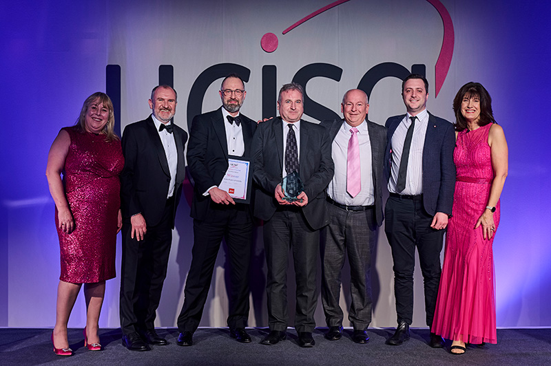 a group of smartly dressed people stood on a stage