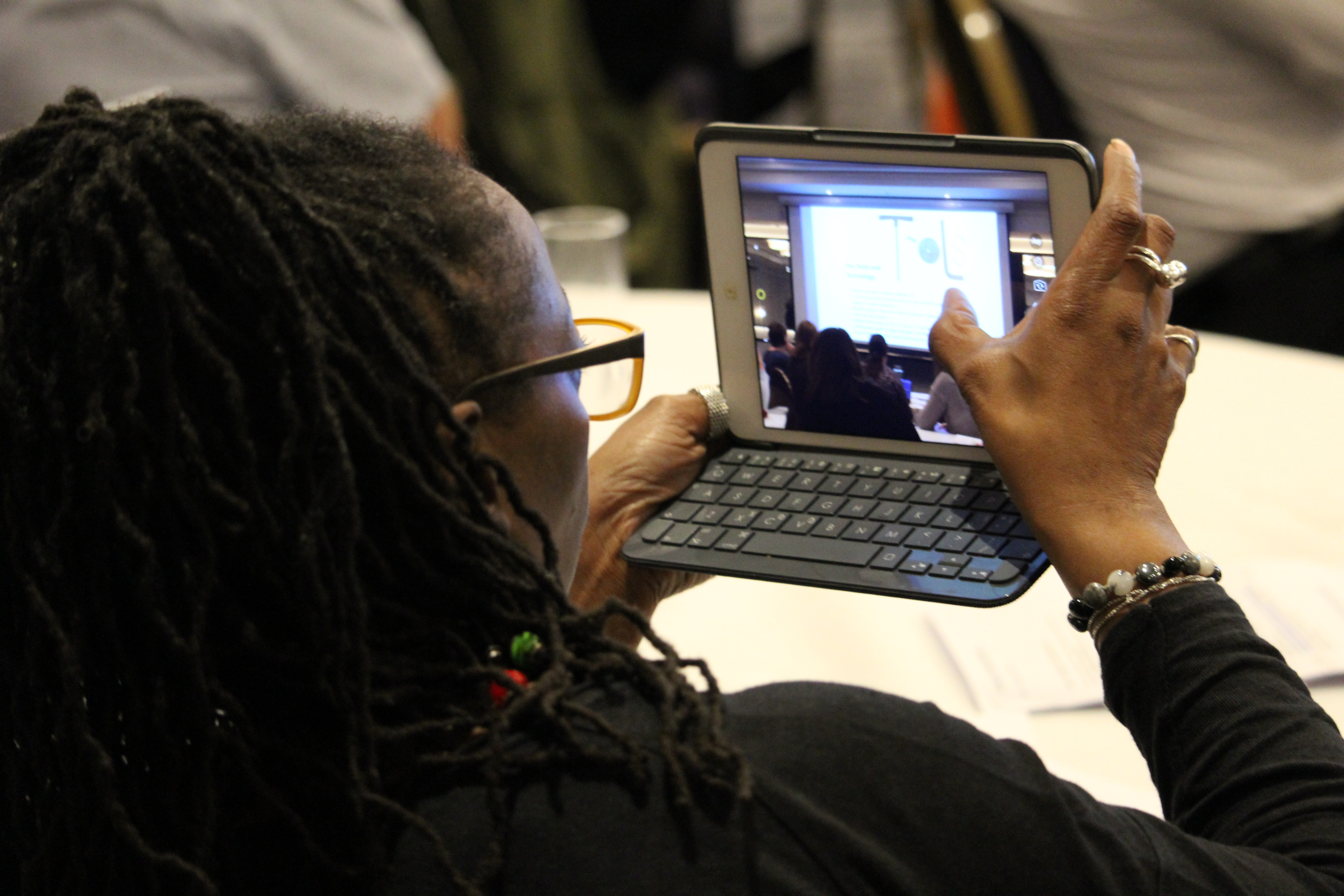 Woman taking a picture using a tablet device