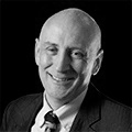 black and white head shot of a man smiling