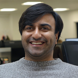 colour head ans shoulders photo of a man smiling