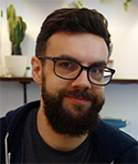 head shoulder pic of man with beard and glasses