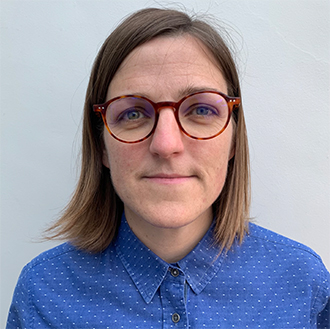 woman with shoulder length hair and glasses looking straight on