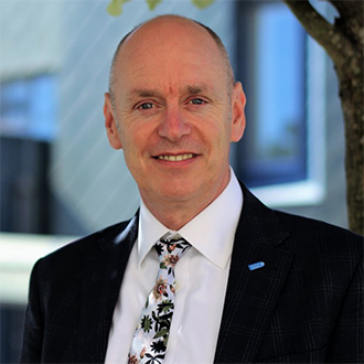 Man in a suit smiling at the camera