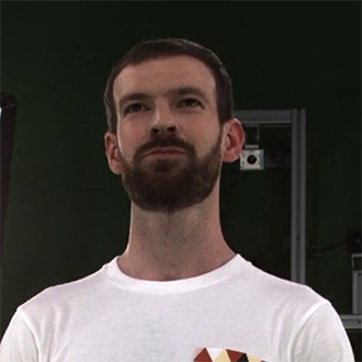 head and shoulders shot of man with a beard in a white t-shirt