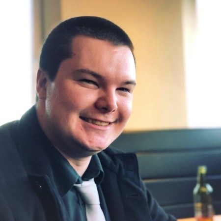 head and shoulder colour photo of a man smiling