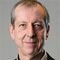 colour head shot of a man smiling