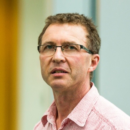 colour head and shoulders shot of a man in glasses