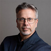 person wearing glasses looking at the camera