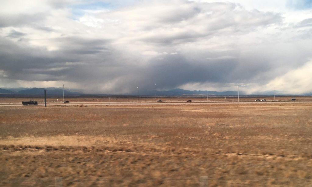 Photograph of landscape with Rocky Mountains in the distance