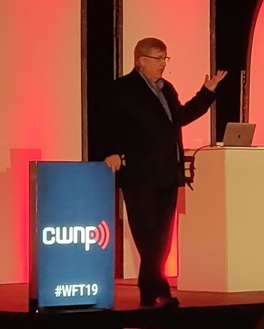 Colour photograph of Keith R Parson presenting on stage at Wi-Fi Trek 2019